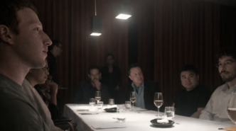 Cinematic scene of a private meeting in a dimly lit room with people seated around a table under pendant lights