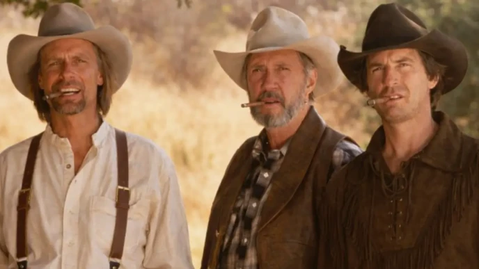 David Carradine standing with two cowboys outdoors in a western-style scene, wearing cowboy hats and holding cigars