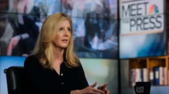 Kathy Ruemmler speaks during a Meet the Press television interview at a studio news desk.