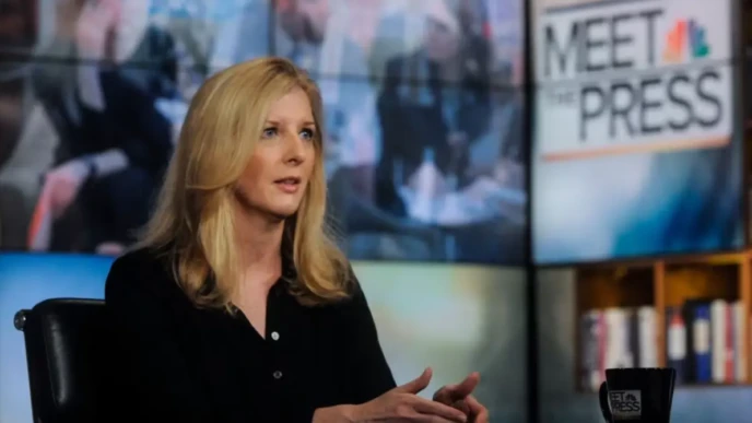 Kathy Ruemmler speaks during a Meet the Press television interview at a studio news desk.