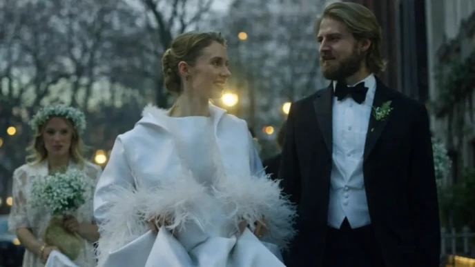 Maya Hawke Wedding scene showing the bride and groom walking together on an evening city street