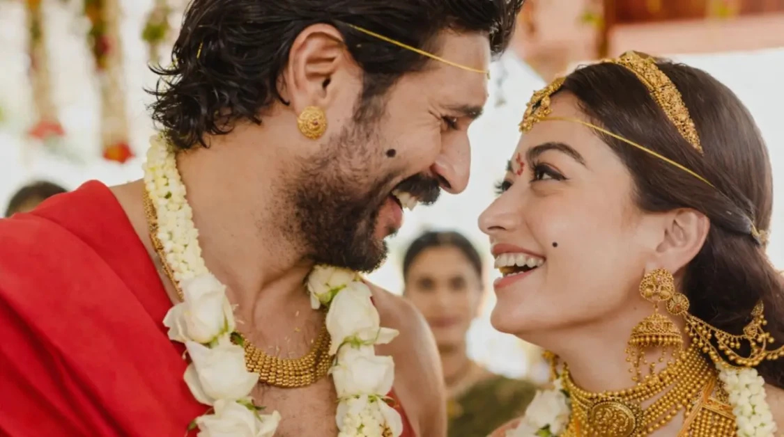 Rashmika Mandanna in traditional wedding jewelry smiling in a close-up romantic ceremony moment