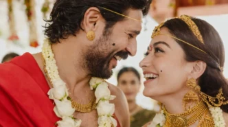 Rashmika Mandanna in traditional wedding jewelry smiling in a close-up romantic ceremony moment