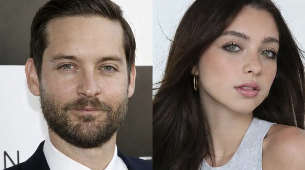 Side-by-side close-up portrait of a Toby Maguire in a navy suit and a young woman with long dark hair wearing a light gray sleeveless top