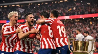Atlético Madrid players celebrate on the pitch after securing a Copa del Rey final place with a 4-3 aggregate victory.