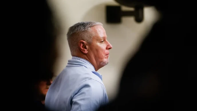 Colin Gray verdict courtroom photo showing a man in profile during trial proceedings, blurred gallery foreground.