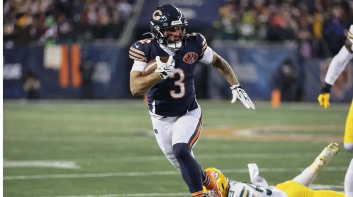 DJ Moore sprints with the football during a Chicago Bears game as a defender falls behind him.