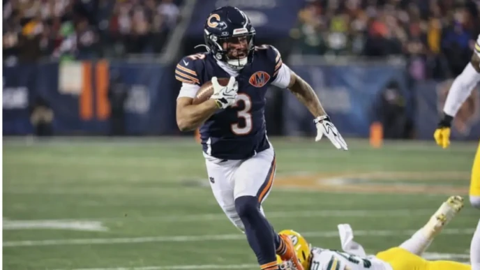 DJ Moore sprints with the football during a Chicago Bears game as a defender falls behind him.