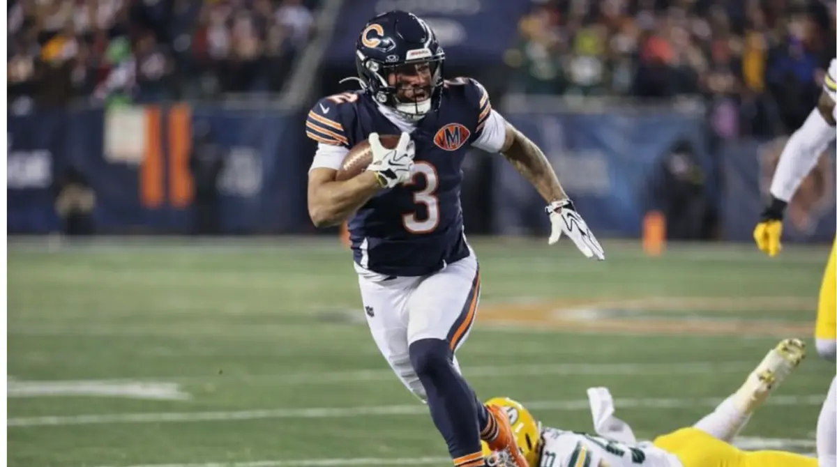 DJ Moore sprints with the football during a Chicago Bears game as a defender falls behind him.