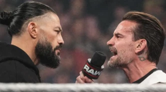 Roman Reigns stares down CM Punk during a heated RAW in-ring confrontation as Punk shouts into a microphone.